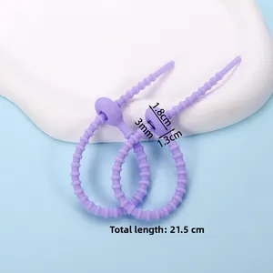 Purple silicone cable tie detail with gear adjustment and total length of 21.5cm