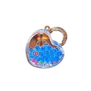 Luminous heart-shaped liquid sand keychain with blue beads and mini floral glitters