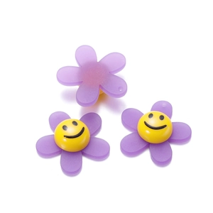 Detailed view of purple acrylic sunflower beads with smiley faces for DIY hair accessories