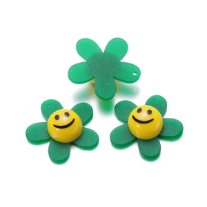 Close-up of DIY acrylic sunflower beads with smiling face design and back hole detail