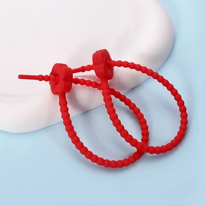 Detailed view of red silicone star-cat paw ties with flexible beaded chain design