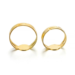 Detail of two adjustable gold-plated DIY ring bases with flat round metal pads for jewelry