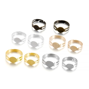 Close-up of adjustable metal ring bases in gold, silver and bronze for DIY jewelry