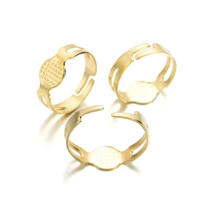 Detailed view of three adjustable golden flat plate ring bases for DIY jewelry making