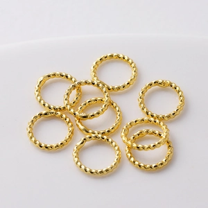 Close-up of textured 18K gold plated twisted rings for DIY jewelry making supplies.