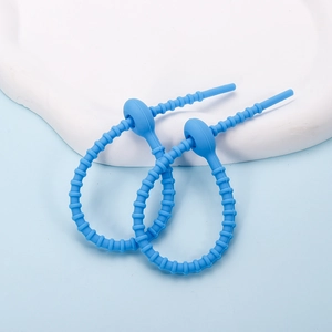 Detail view of sky blue silicone cable ties with ribbed texture and loop fastener