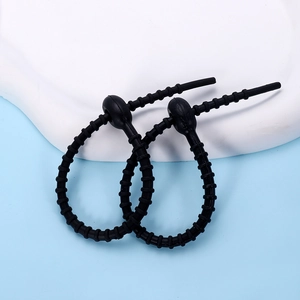 Detail of adjustable black silicone cable ties with multi-stage beaded locking structure