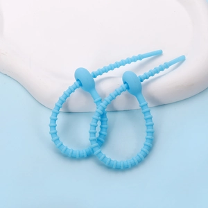 Detail view of sky blue flexible silicone cable ties with cat paw design for cable organizing