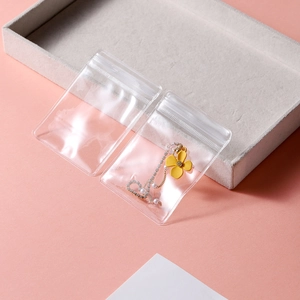 Close-up of thick transparent PVC jewelry bag protecting beaded earrings with a seal