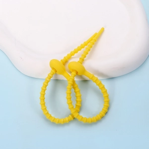 Close-up of adjustable yellow silicone cable ties with non-slip star cat claw design
