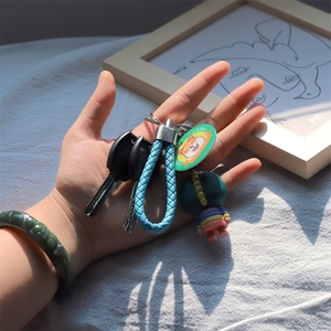 Creative hand-woven sky blue PU leather rope keychain with dinosaur and shiba inu charms