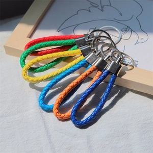 Colorful hand-woven PU leather cord keychains with silver metal rings in various colors
