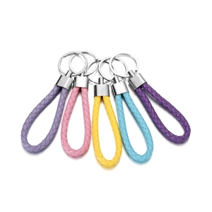 Close-up of colorful braided PU leather keychains in pastel tones with silver metal rings
