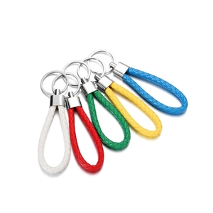 Close-up of five colorful braided PU leather keychains in white, red, green, yellow, and blue