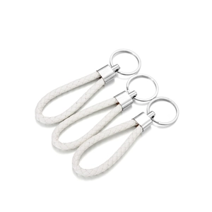 Close-up of white braided PU leather keychains with polished silver metal rings