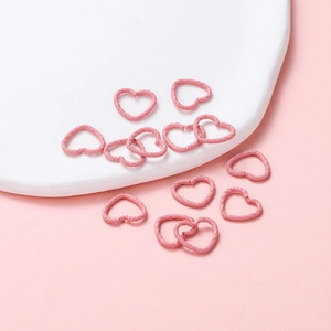 Pink heart-shaped metal jump rings with unique hammered texture for DIY jewelry making