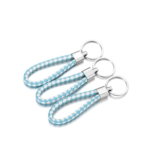 Close-up of blue and white braided PU leather keychains with silver metal rings