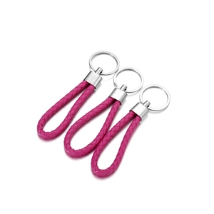 Detailed view of three rose red braided PU leather keychains with silver metal rings
