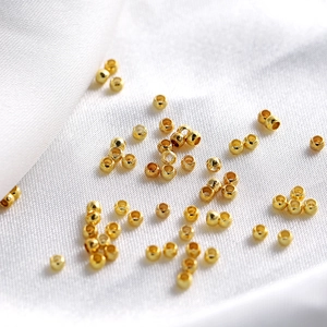 Macro shot of polished 18K gold plated copper spacer beads for DIY jewelry making