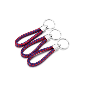 Detail of three braided PU leather keychains with shiny silver metal rings and clips