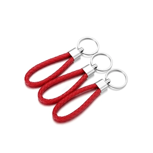 Close-up of three red braided PU leather keychains with polished silver metal rings