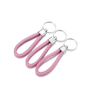 Detailed view of three pink hand-braided PU leather keychains with silver metal rings
