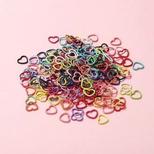 Close-up of colorful heart-shaped connector rings with unique embossed textured finish