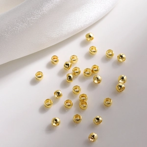 Macro shot of 18K gold plated barrel spacer beads with polished finish for jewelry making