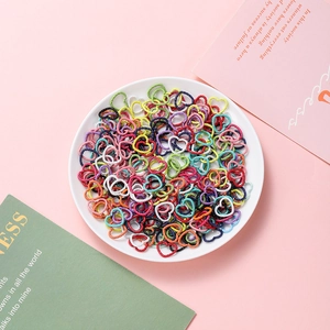 Colorful heart-shaped open jump rings for DIY jewelry making accessories shown in a bowl