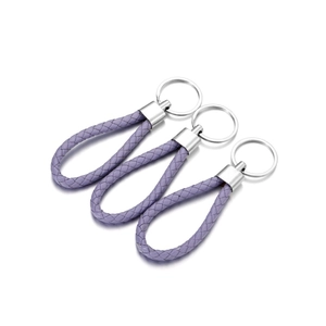Detailed close-up of purple woven PU leather keychains with polished silver metal rings