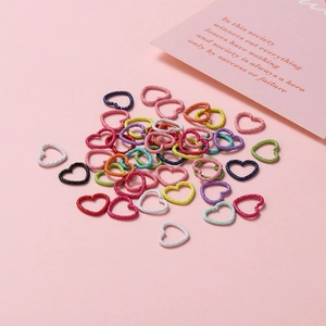 Macro shot of colorful heart-shaped textured metal jump rings for DIY jewelry making projects