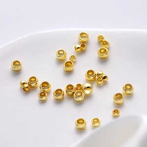 Macro shot of 18K gold plated jewelry positioning beads in various sizes for DIY making