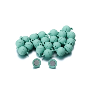 Macro shot of mint green magnetic clasps with semi-sphere design for DIY jewelry making
