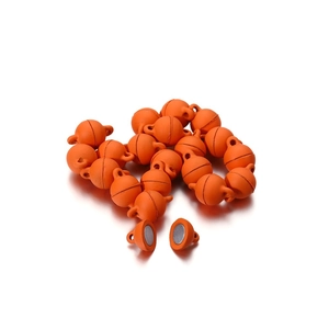 Detail view of round magnetic jewelry clasps in bright orange for DIY necklaces