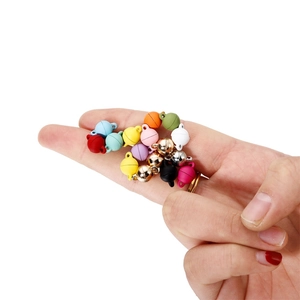 Close-up of colorful round magnetic jewelry clasps in hand for DIY bracelet making