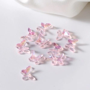 Macro shot of iridescent resin butterfly charms for DIY crafts and nail art decoration
