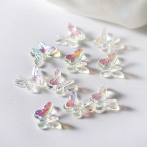 Macro shot of iridescent 3D resin butterfly charms for DIY nail art and jewelry making