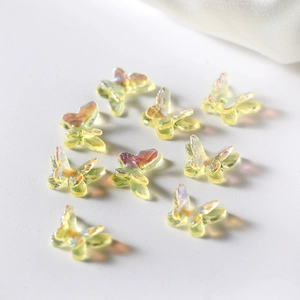 Close-up of nine 3D resin butterfly charms with Aurora finish for DIY jewelry and nail art
