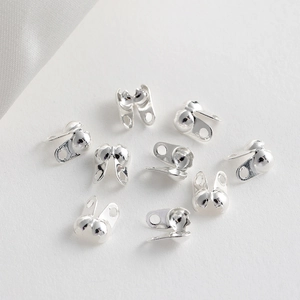 Detailed view of silver plated spherical bead chain connectors for DIY jewelry making
