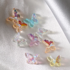 Aurora resin mini butterflies for nail art and DIY jewelry on silver silk background