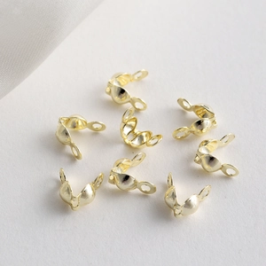 Macro shot of 18K gold plated jewelry end clasps for DIY necklace bead chain assembly
