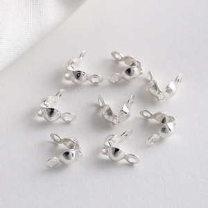 Detailed view of silver-plated bead tips with double loops for DIY jewelry making