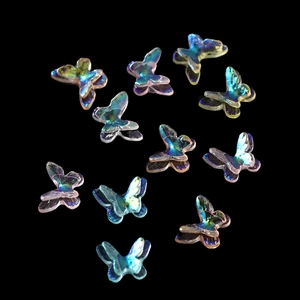 Macro shot of colorful iridescent resin butterfly charms with vibrant dual-wing details