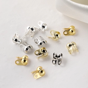 Macro detail of 18K gold and silver bead tips for DIY jewelry making and connectors