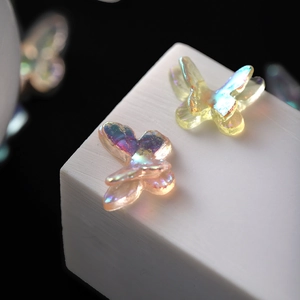 Macro detail of aurora finish resin butterflies for jewelry making and nail art