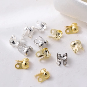 Detailed macro view of gold and silver bead tips for jewelry making and necklace connection