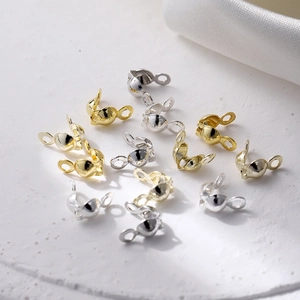 Close-up of gold and silver open bead tips for DIY jewelry necklace connections