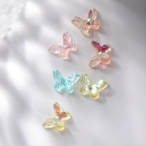 Macro view of six colorful aurora butterfly resin charms for DIY jewelry and nail art