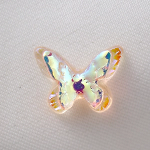 Detailed view of iridescent resin butterfly with AB coating and gold wing accents