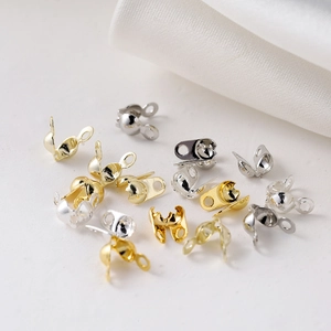 Macro shot of 18K gold and silver bead chain connector clasps for DIY jewelry